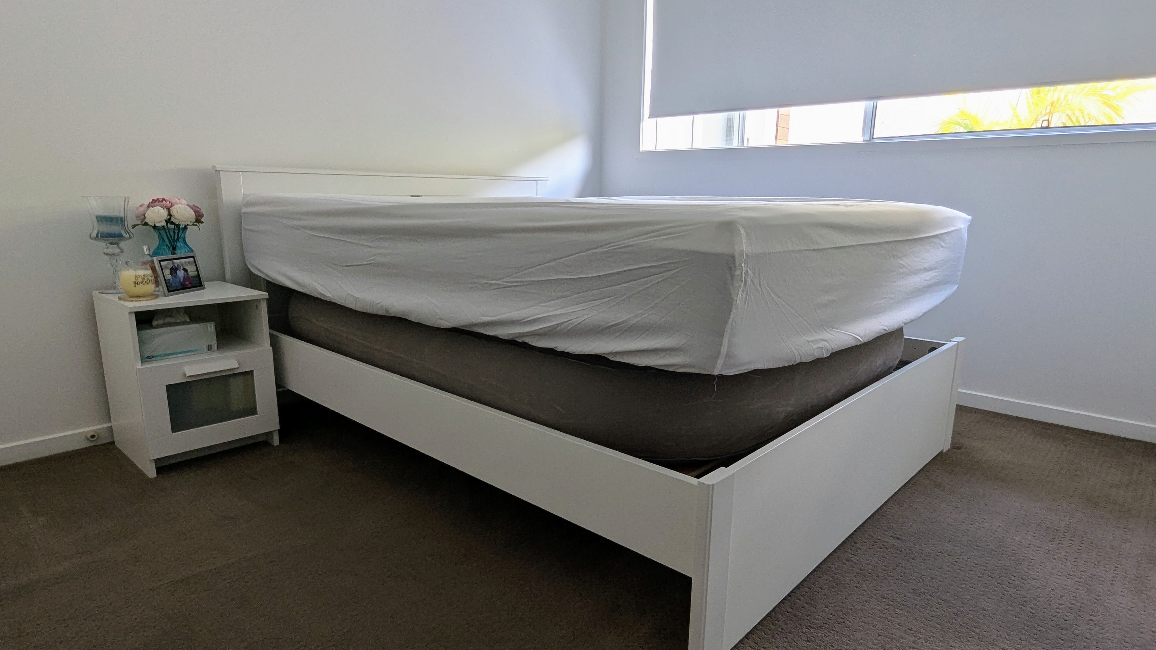 Queen bed, shown side on, with Bedezy inflated to lift the mattress up out of a bed frame where the mattress would normally be partially recessed. 